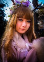 A young woman in the park on a cold winter's day, posing for a group of photographers.